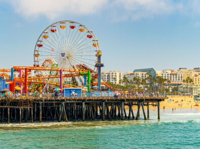 a pier with a ferris wheel and a roller coaster