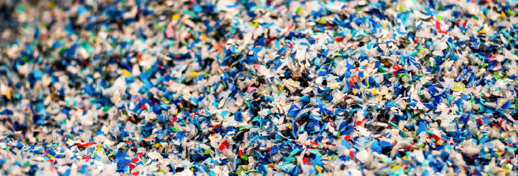 Vast accumulation of tiny colorful microplastic fragments showing the scale of plastic pollution