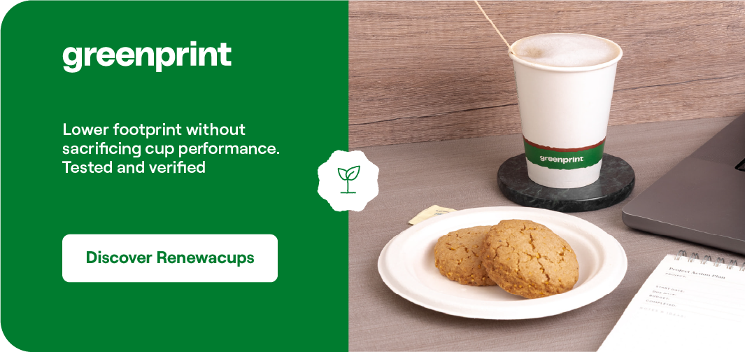 Greenprint Renewacup on a wooden desk alongside cookies showing sustainable foodservice packaging in everyday use