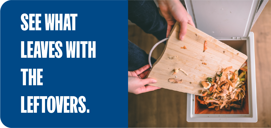 Two people scraping kitchen food scraps from a cutting board into a food waste composting bin