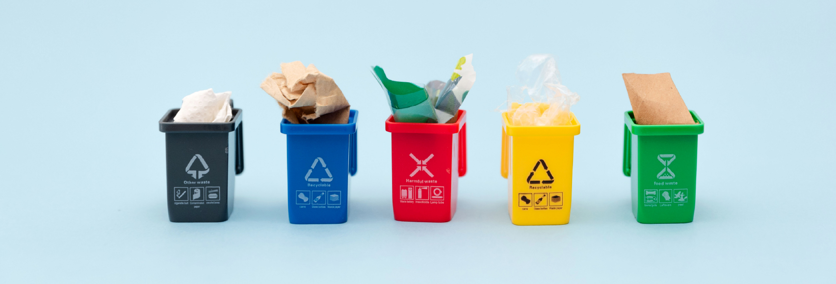 Color-coded waste sorting bins for recyclables, food waste, and trash showing how the 3 R's of waste management work